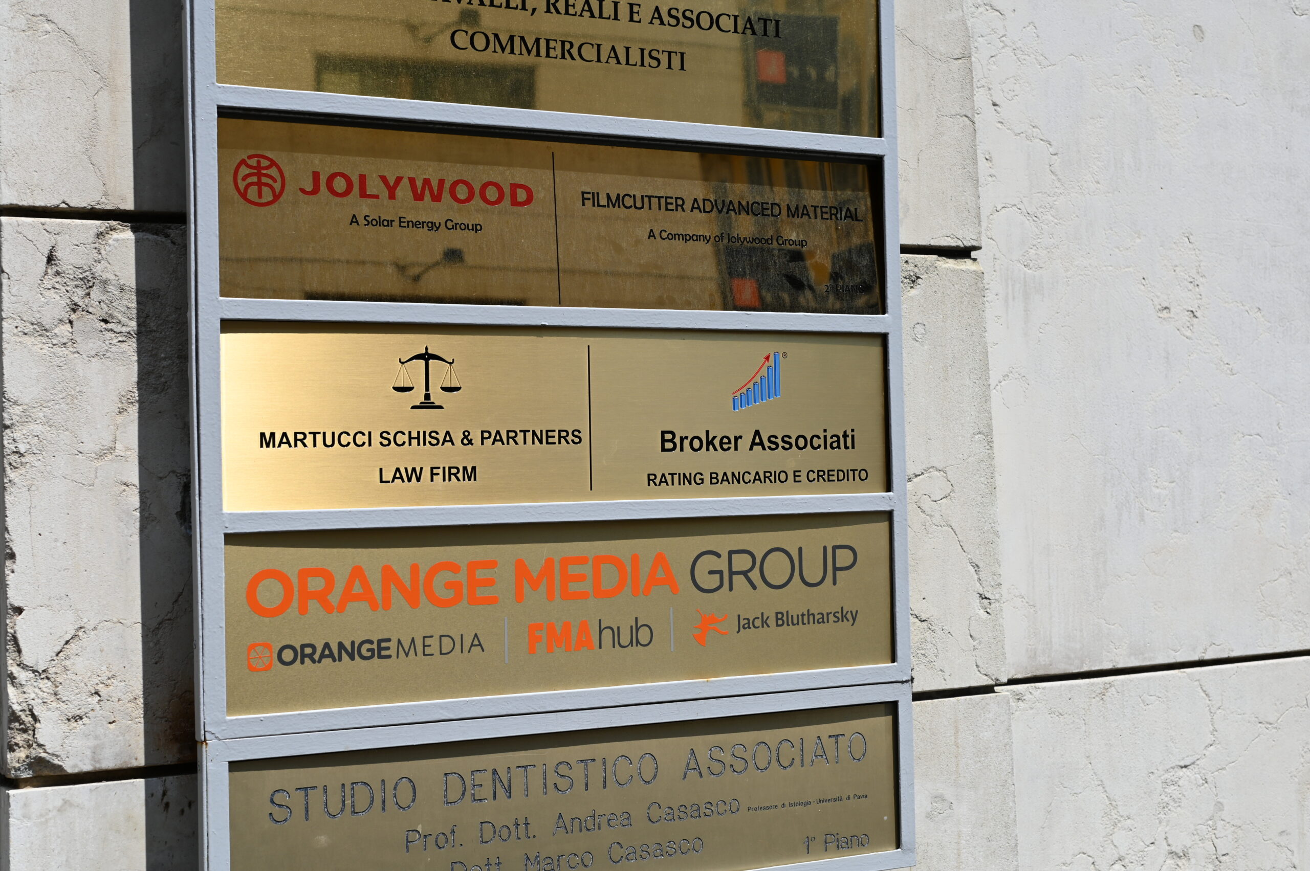 Entrance plaque at Piazzetta Umberto Giordano 2 in Milan showing Broker Associati