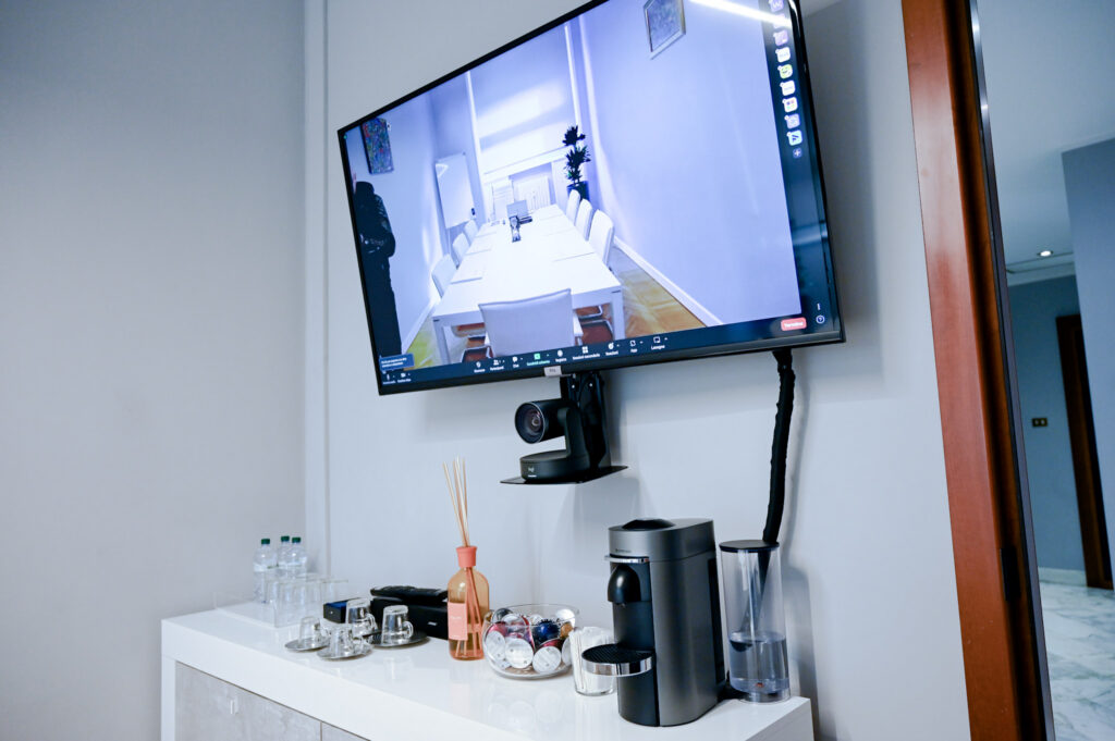 Coffee area and video conferencing screen in the Milan San Babila office